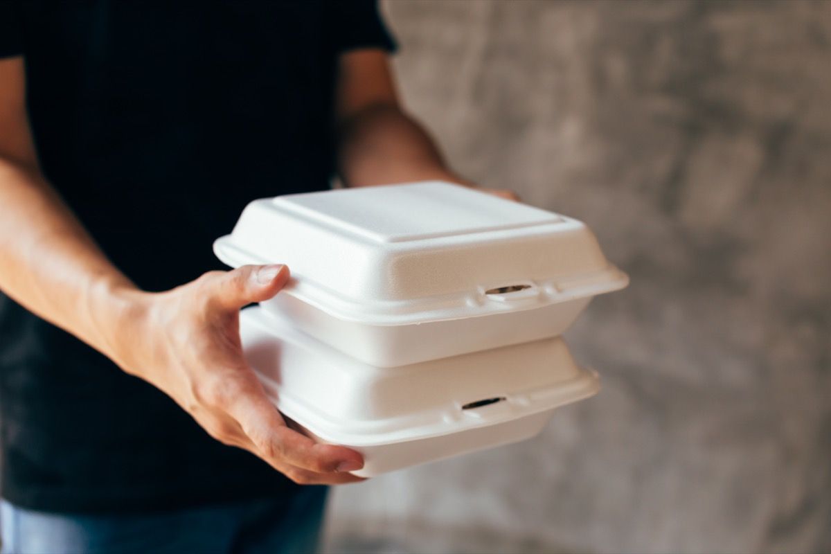 ภาพระยะใกล้ของคนส่งของกำลังส่งกล่องโฟมอาหารกลางวัน - กล่องโฟมเป็นขยะพลาสติกที่เป็นพิษ สามารถใช้ในการรีไซเคิลและแนวคิดการประหยัดสิ่งแวดล้อม