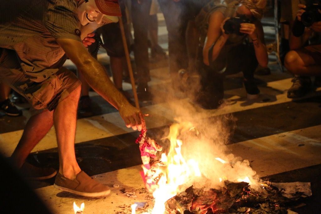 un hombre quemando la bandera estadounidense fuera de la convención democrática de 2016