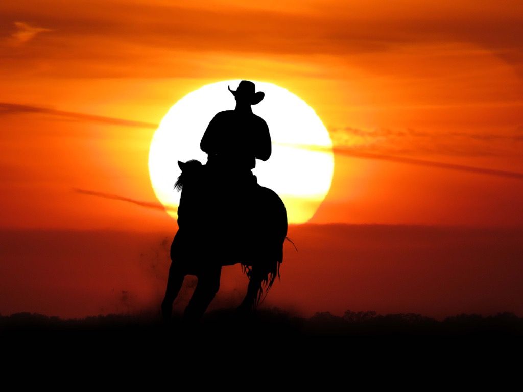 un vaquero literalmente cabalgando hacia la puesta de sol - mitos americanos
