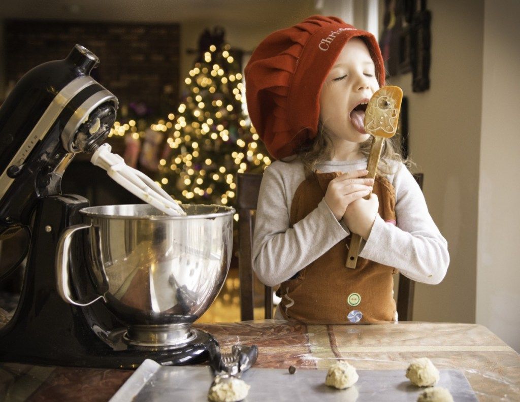 Maža mergaitė gamina sausainius per Kalėdas