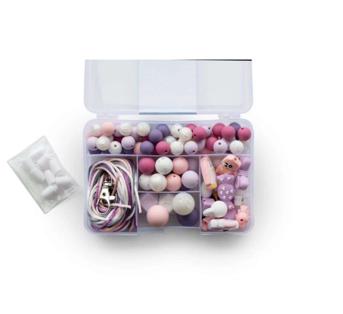 rozā un purpursarkanas silikona pērlītes skaidrā kastē