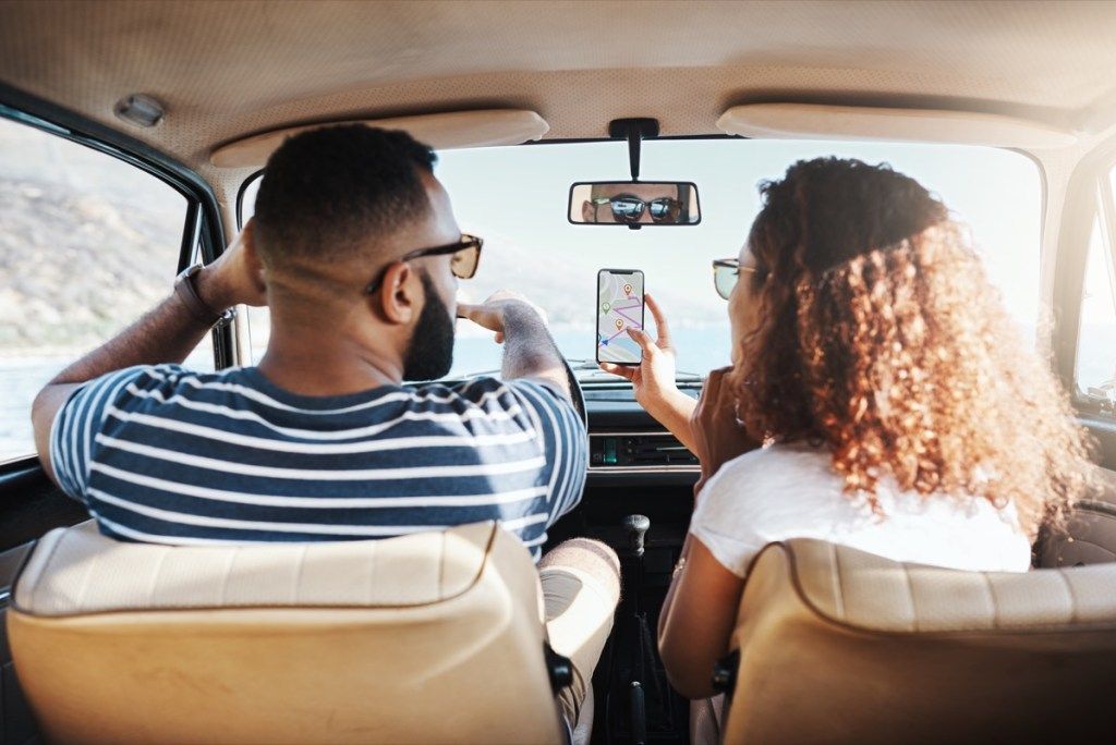 ungt par, der bruger en GPS-maskine i deres bil, NASA-hverdagsartikler