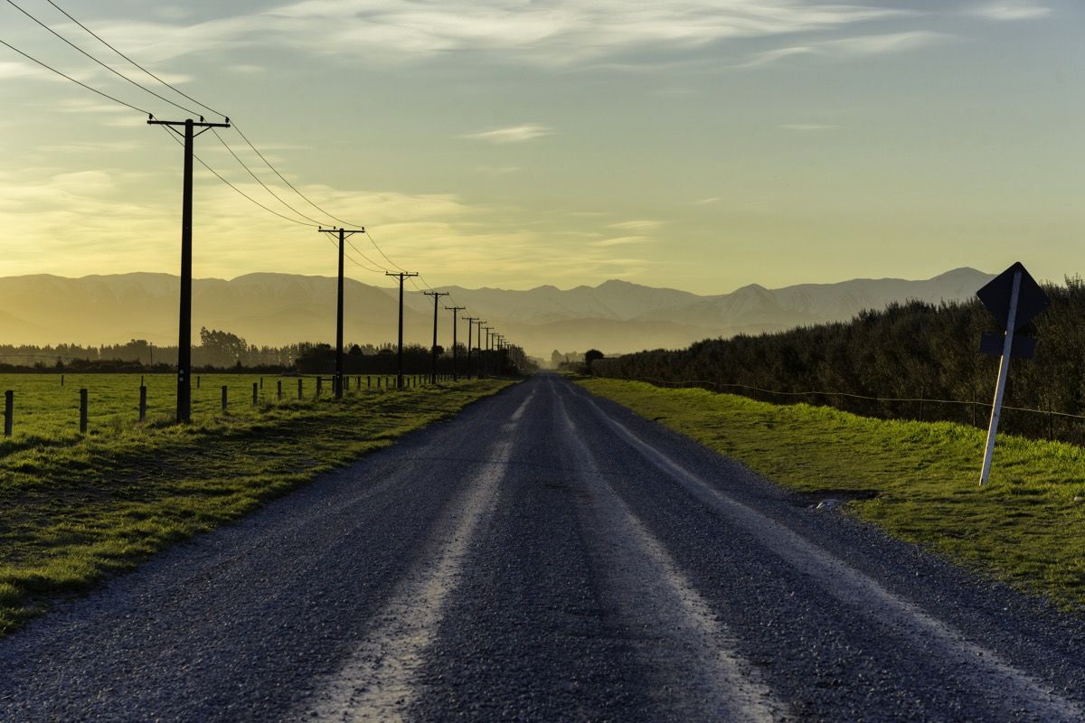 sončni zahod se približa na cesti, ki vodi proti južnim Alpam na Novi Zelandiji