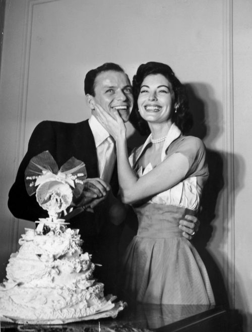   Frank Sinatra y Ava Gardner de pie detrás de su pastel de bodas el día de su boda en 1951