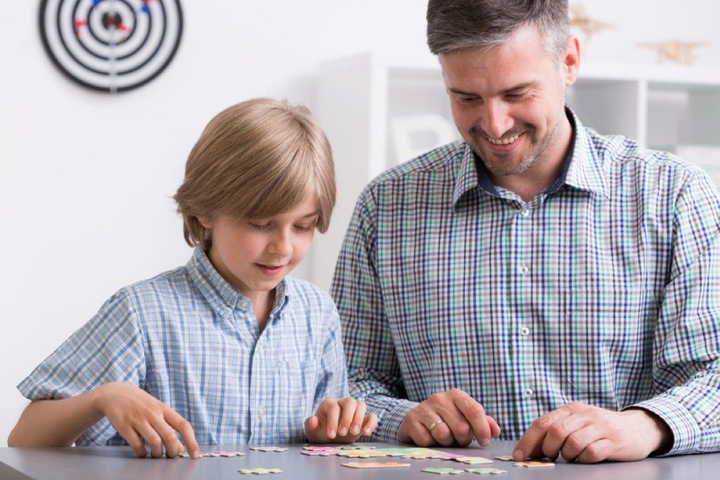 pria dan anak laki-laki mengerjakan teka-teki bersama, cara untuk merasa luar biasa