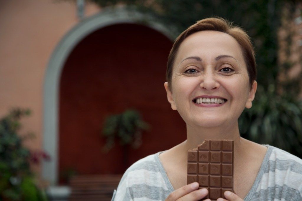 Starší žena jíst čokoládu, způsoby, jak se cítit úžasně