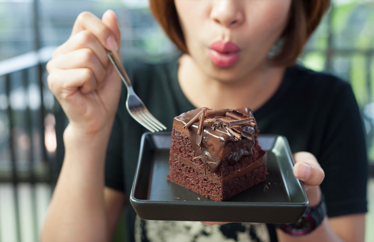 kvinde spiser chokoladekage med en gaffel