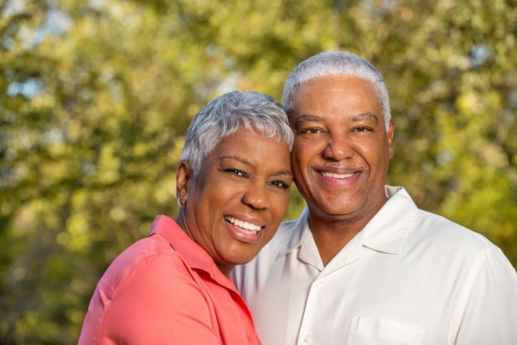 vyresnė pora šypsosi lauke