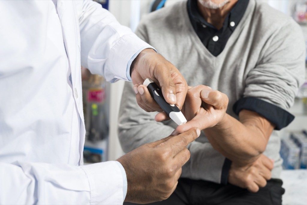 Мужчина проходит тест на диабет в кабинете врача