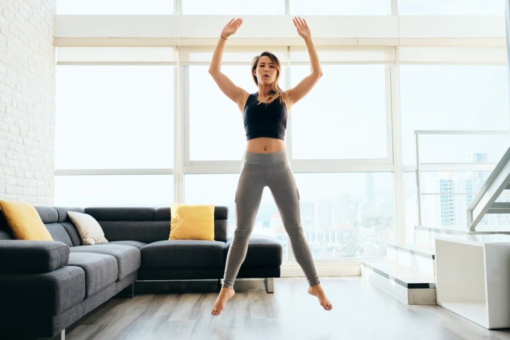 Sieviete, jumping, un, treniņš, ārējs, pa, dzīvojamā istaba