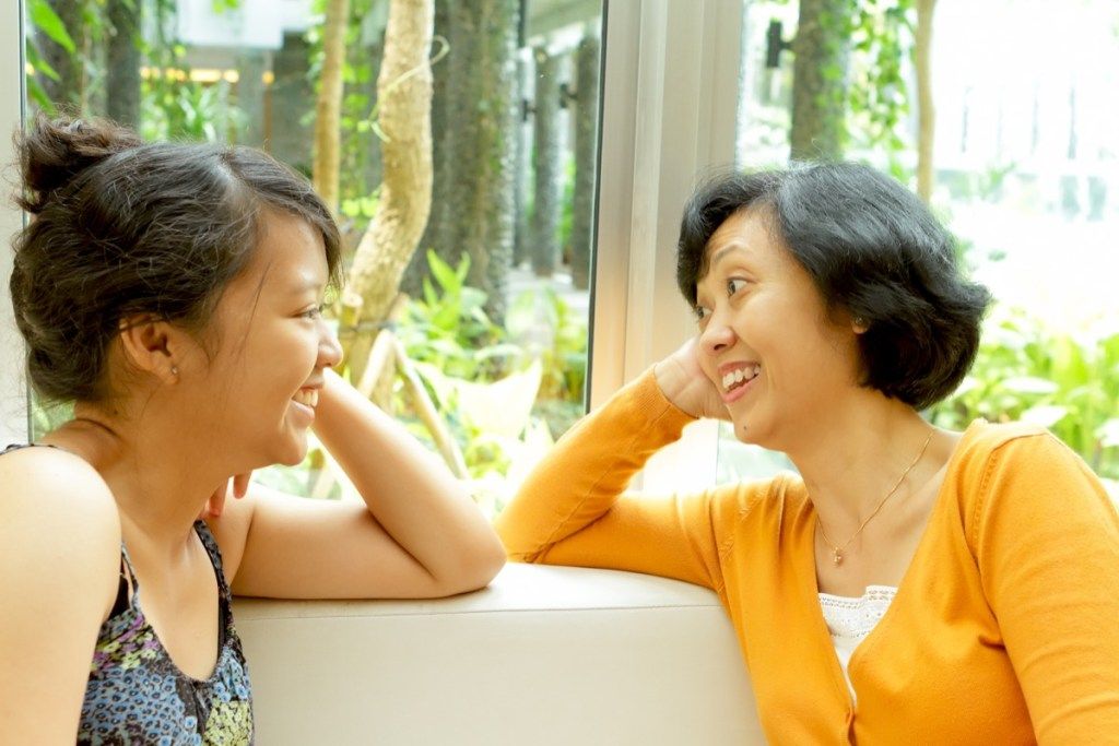 glad asiatisk mor og datter snakker