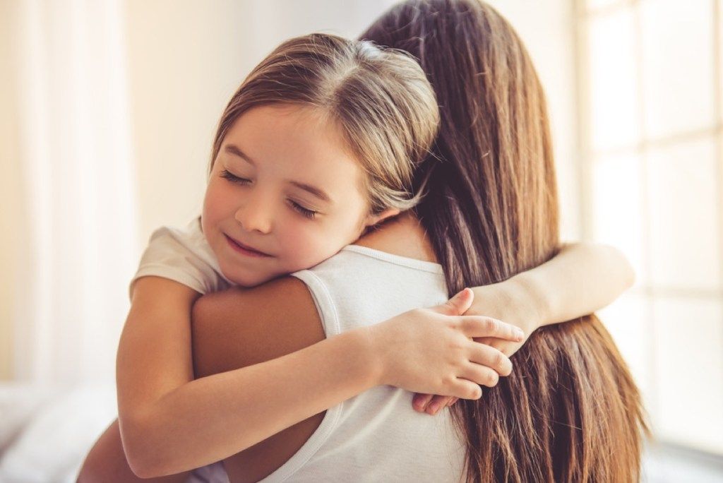 junges Mädchen umarmt ihre Mutter, Fähigkeiten, die Eltern Kindern beibringen sollten