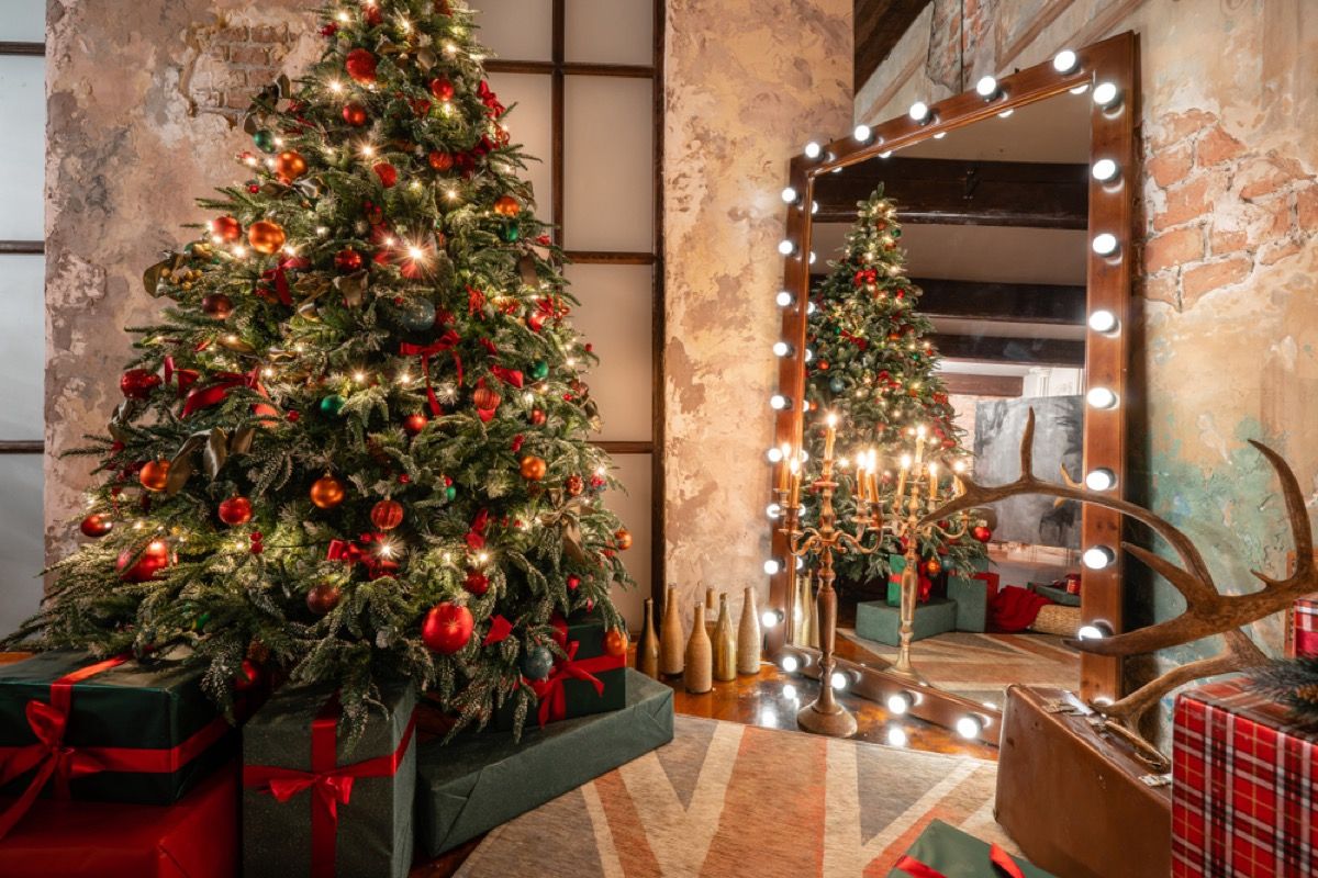 Kalėdų eglutė palėpėje, papuošta raudonais ir auksiniais ornamentais su atitinkamu vyniojamuoju popieriumi