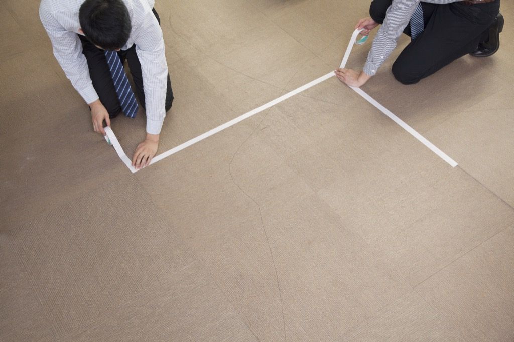 Hombres delineando el tamaño de los muebles con cinta {Consejos de compra de Ikea}