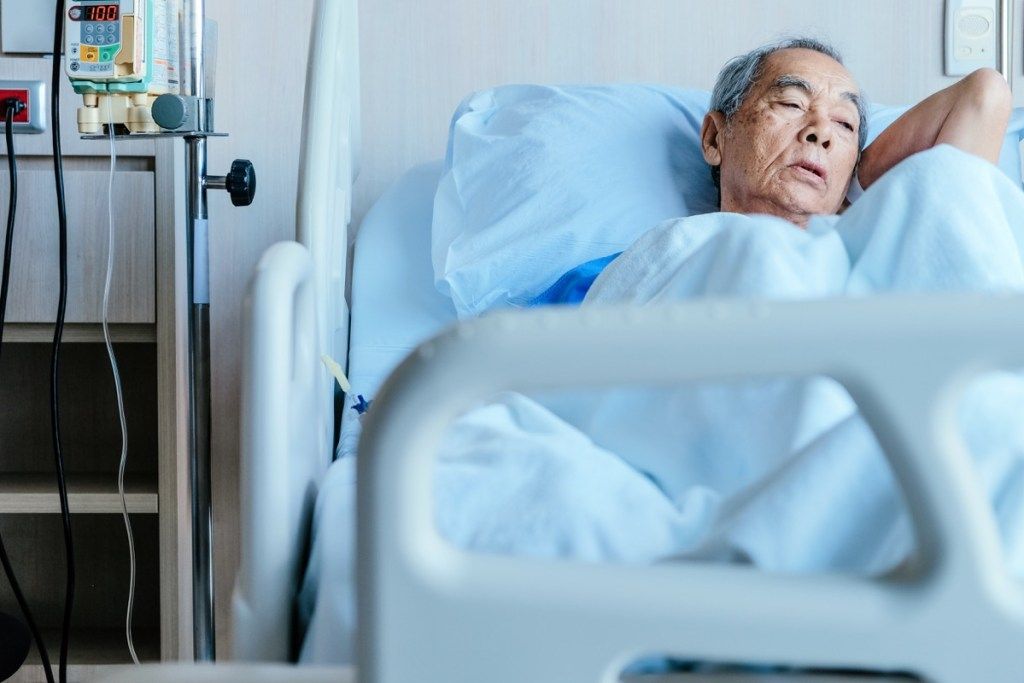 ชายชราชาวเอเชียนอนอยู่บนเตียงในโรงพยาบาลเสียใจกว่า 50 คน