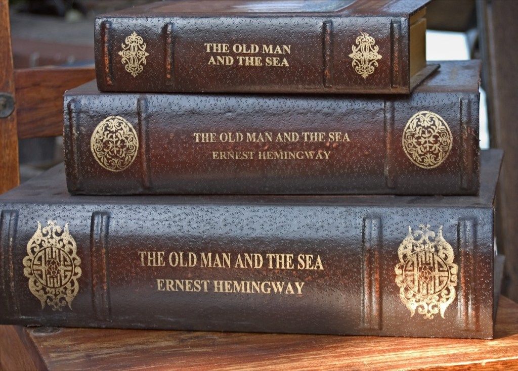 Kolm virnastatud nahast köidetud raamatut, mille autor on Ernest Hemingway. - Pilt