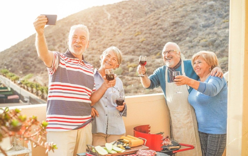 възрастни двойки, които правят снимки, докато пият вино, намаляват размера на дома ви