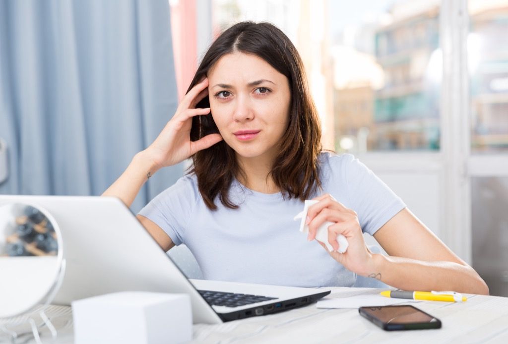 La mujer está trabajando en su computadora portátil y se siente ofendida por lo que alguien dijo.