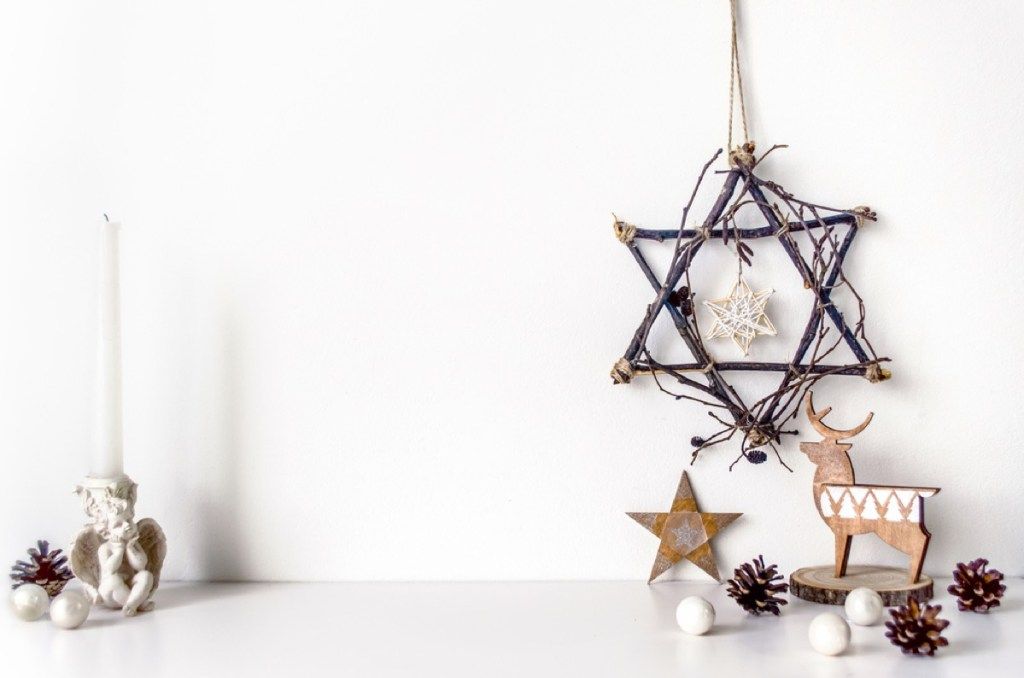 stella di david fatta di rami e decorazioni hanukkah sul tavolo bianco