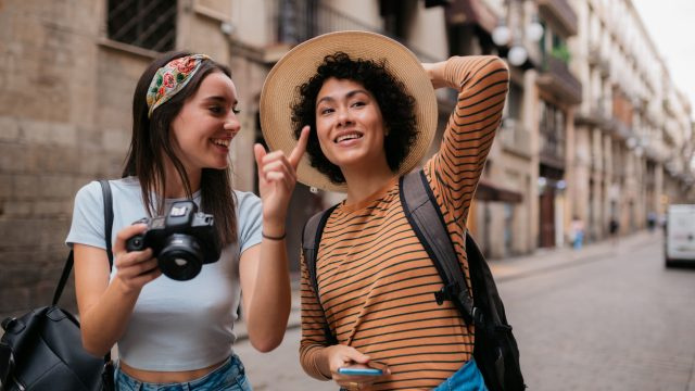   Hai người phụ nữ đi dạo trên phố với máy ảnh trong một chuyến đi