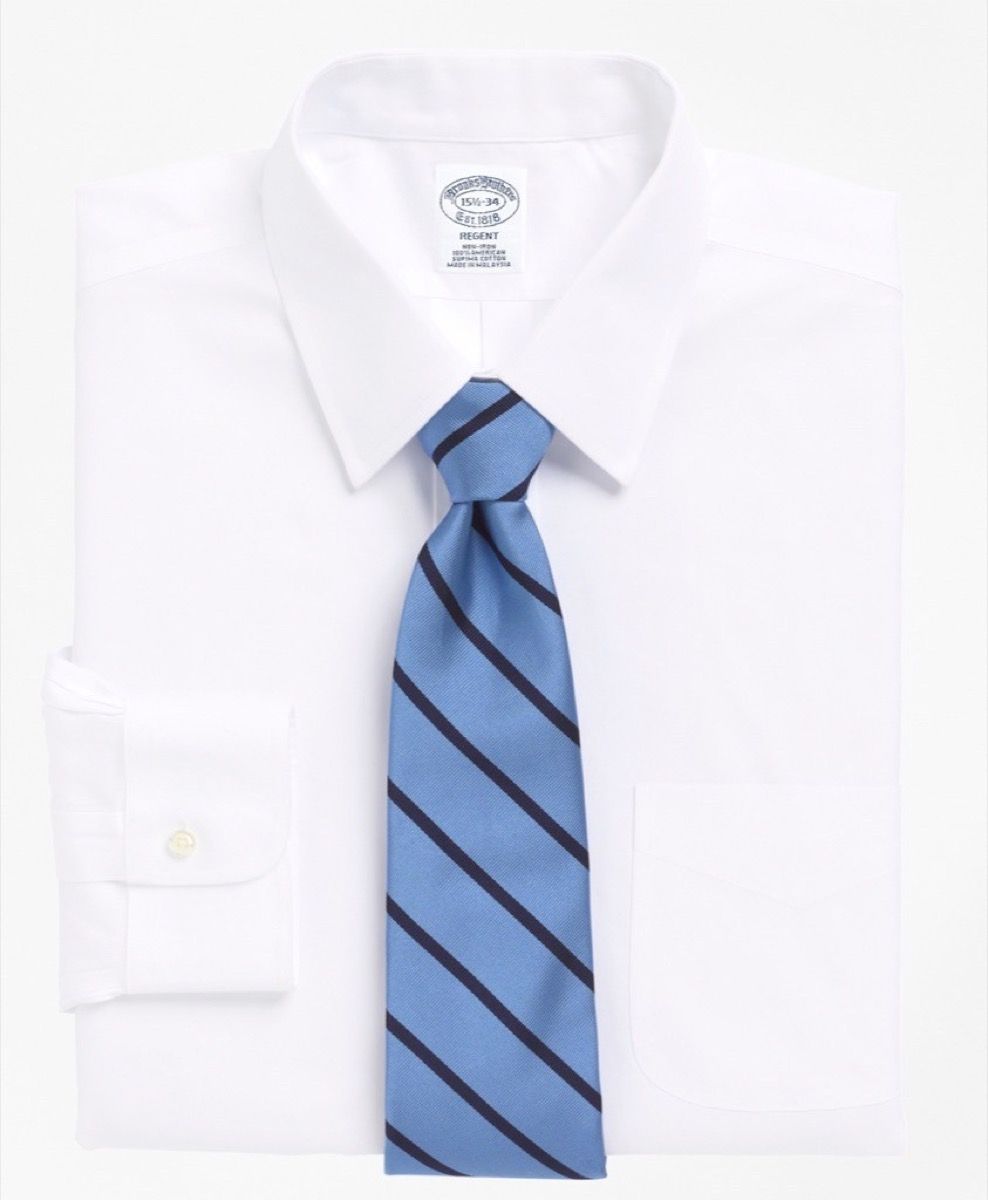 valkoinen napitettava paita ja sininen raidallinen solmio